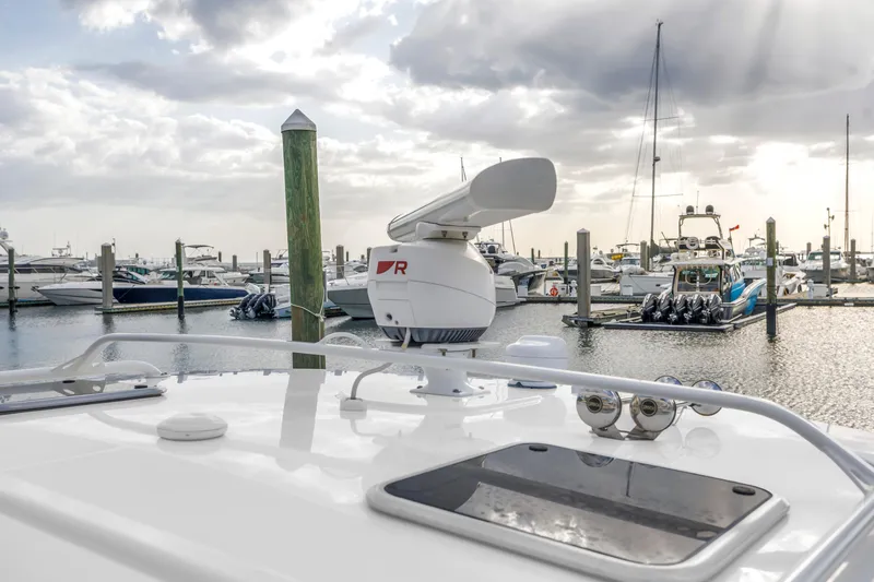 Slide: The Image of Boston Whaler 380 Realm 2022 at marina with radar and boats in background. - 33