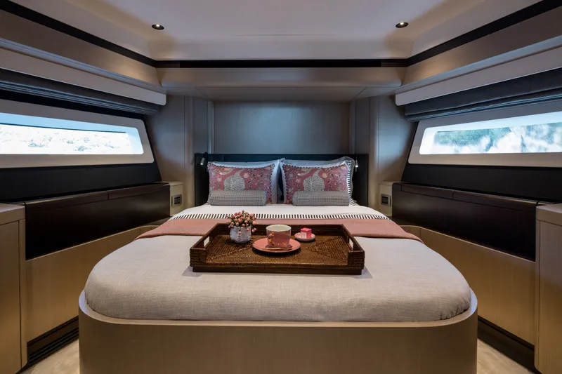 Slide: The Image of Luxurious Sirena 48 yacht bedroom interior, 2027 model, featuring elegant bedding and a breakfast tray. - 34