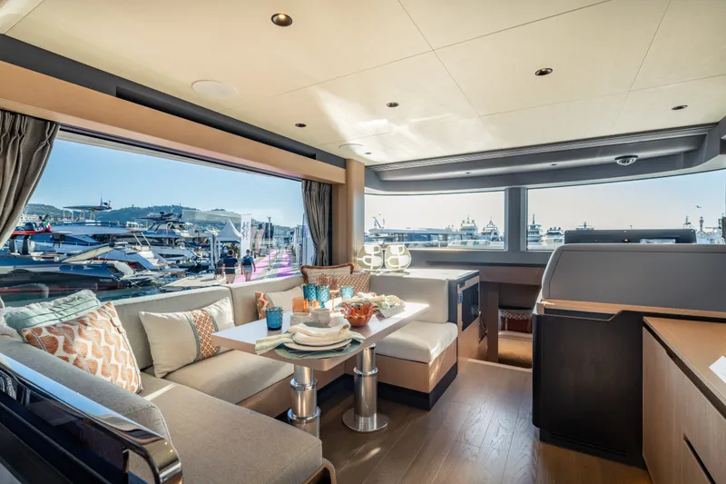 Slide: The Image of Interior of a luxury yacht with stylish seating and large windows overlooking the harbor. - 25