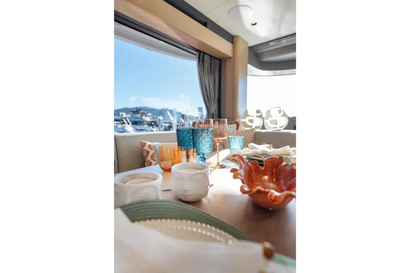 Slide: The Image of Elegant table setting on Sirena 48 yacht, 2027 model, with scenic marina view. - 28