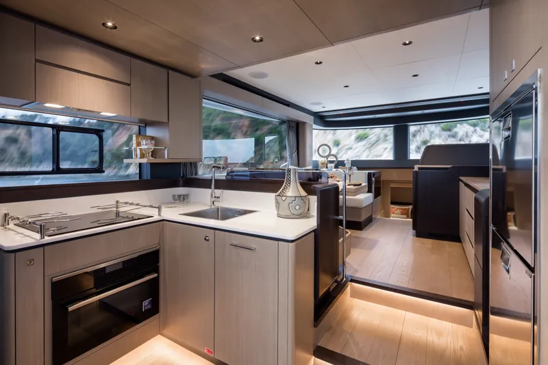Slide: The Image of Luxurious interior of 2027 Sirena 48 yacht featuring modern kitchen and dining area. - 24
