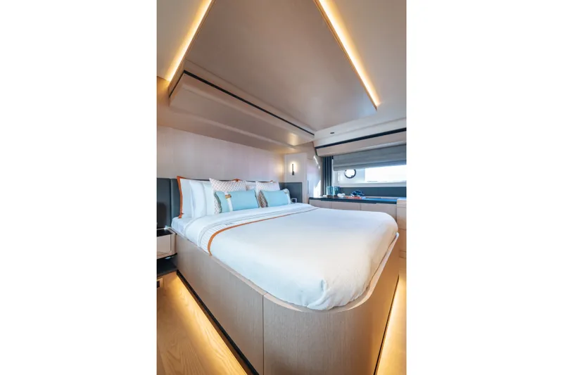 Slide: The Image of Luxurious bedroom interior of 2027 Sirena 48 yacht, featuring modern design and ambient lighting. - 33