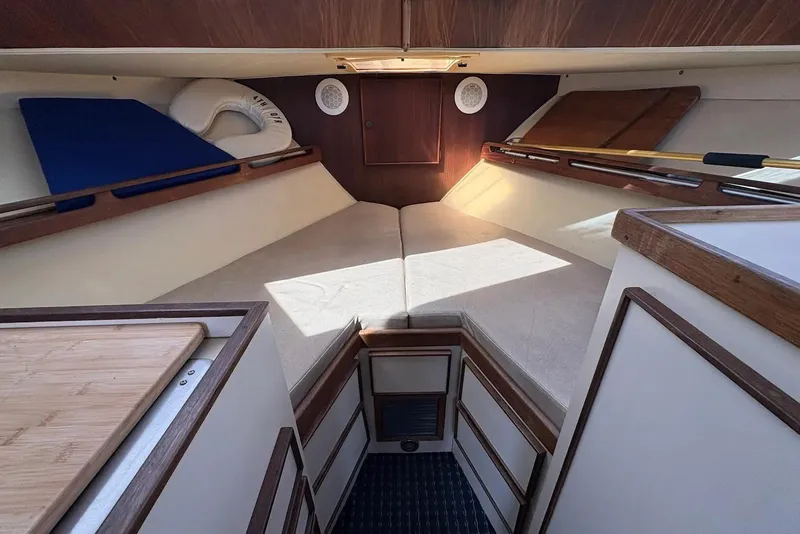 Slide: The Image of Interior cabin of a 1983 Hatteras Yachts 32, featuring cozy sleeping quarters. - 7