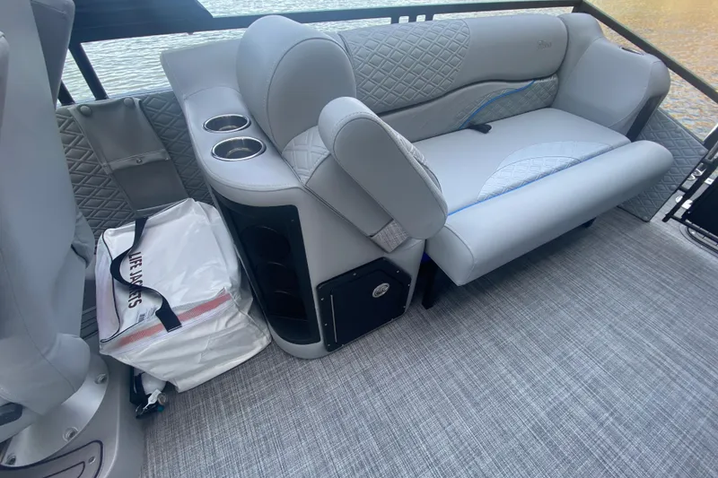 Slide: The Image of Luxurious seating on 2025 JC Sporttoon 26TT boat with life jackets and cup holders. - 10