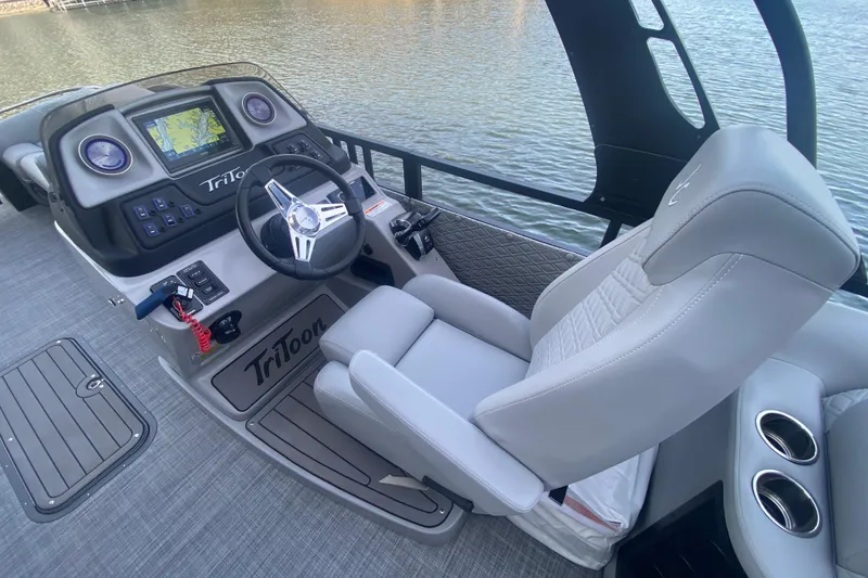 Slide: The Image of Helm of 2025 JC Sporttoon 26TT boat with modern controls and comfortable seating. - 15
