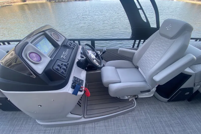 Slide: The Image of 2025 JC Sporttoon 26TT boat cockpit with steering wheel and comfortable captain's chair. - 16