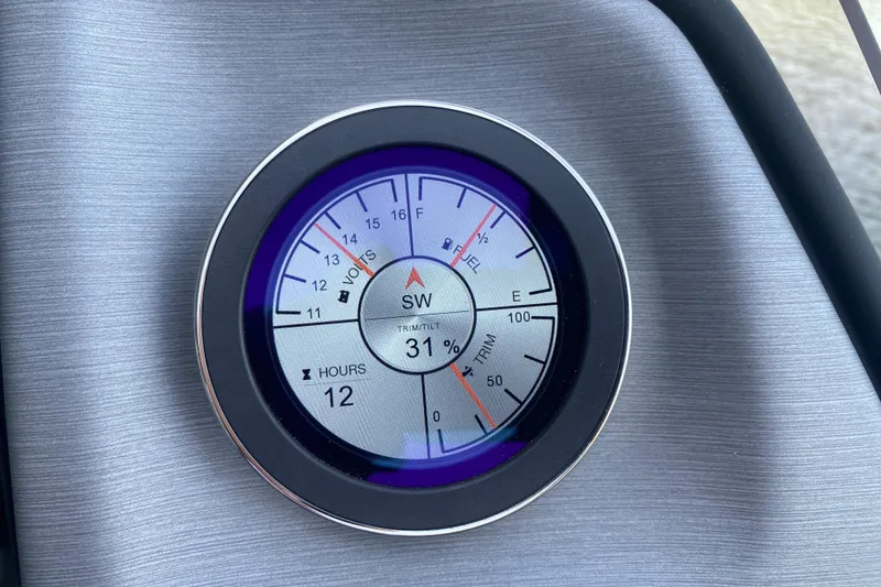 Slide: The Image of Dashboard gauge of 2025 JC Sporttoon 26TT showing fuel, volts, and trim levels. - 22