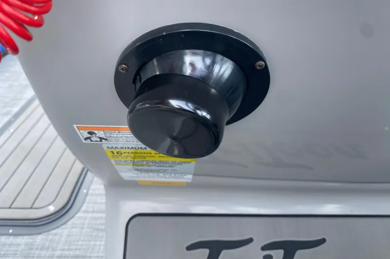 Slide: The Image of Close-up of a 2025 JC Sporttoon 26TT boat component with safety label. - 26