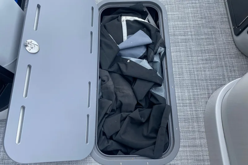 Slide: The Image of Storage compartment on JC Sporttoon 26TT boat, 2025 model, with fabric inside. - 31