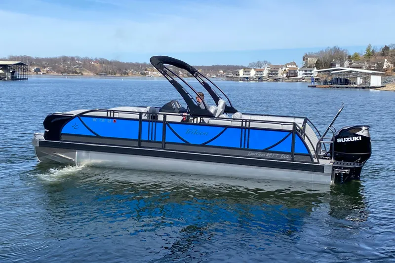 Slide: The Image of 2025 JC Sporttoon 26TT pontoon boat with Suzuki engine on a lake. - 4
