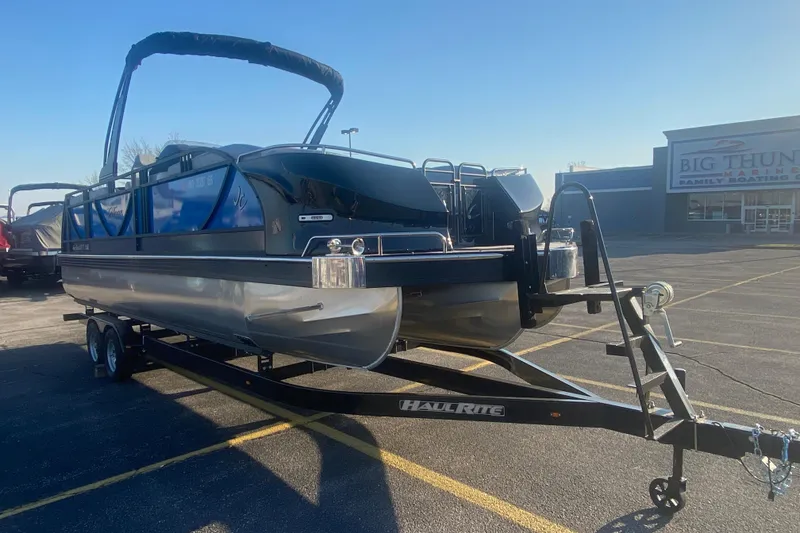Slide: The Image of 2025 JC Sporttoon 26TT pontoon boat on trailer in parking lot, sunny day. - 42
