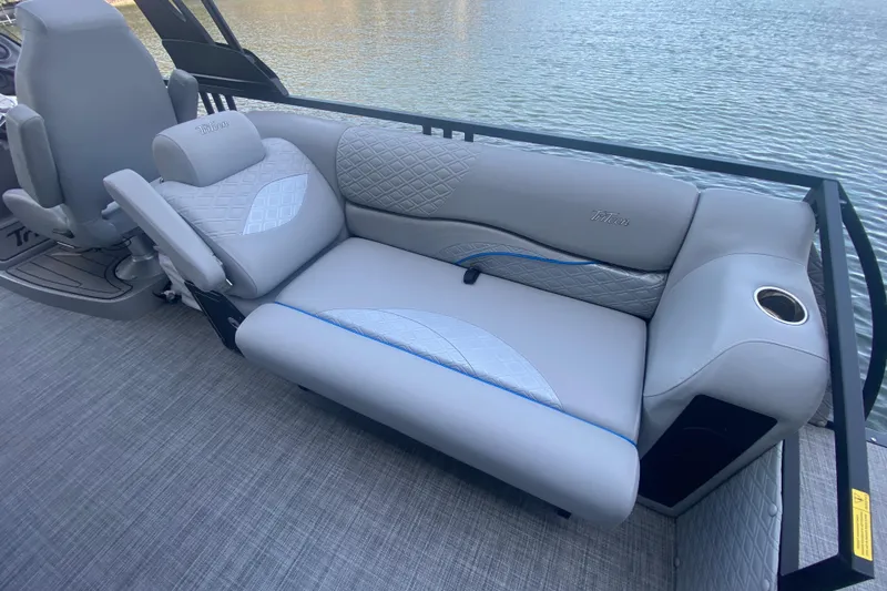 Slide: The Image of Luxurious seating on 2025 JC Sporttoon 26TT pontoon boat by the water. - 9