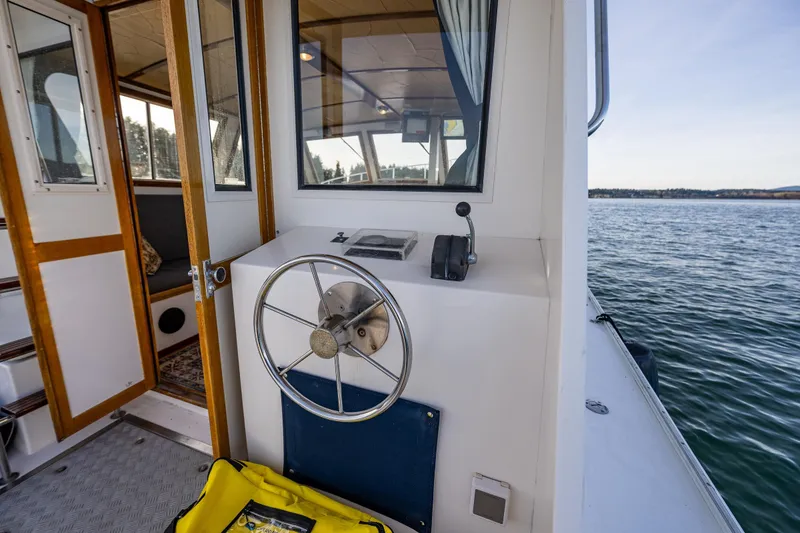 Slide: The Image of Steering area of a 1999 Northern Bay 36 boat with scenic water view. - 11