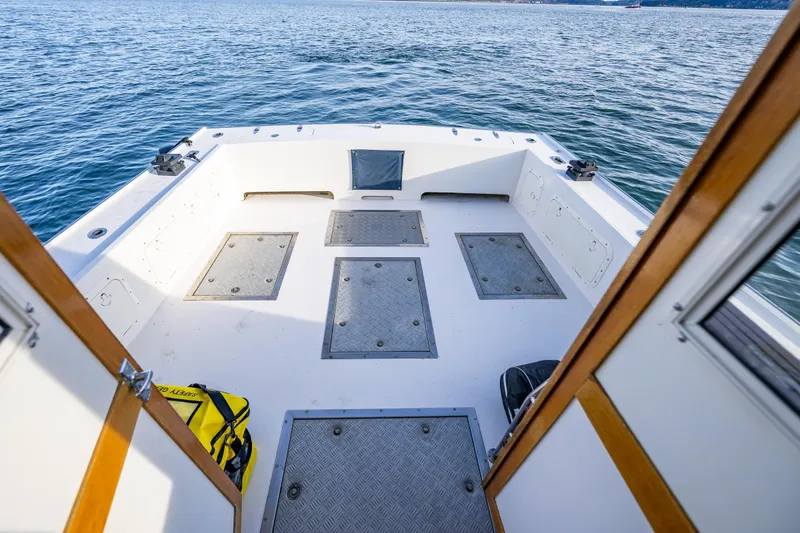 Slide: The Image of Spacious deck of 1999 Northern Bay 36 boat on calm water. - 12