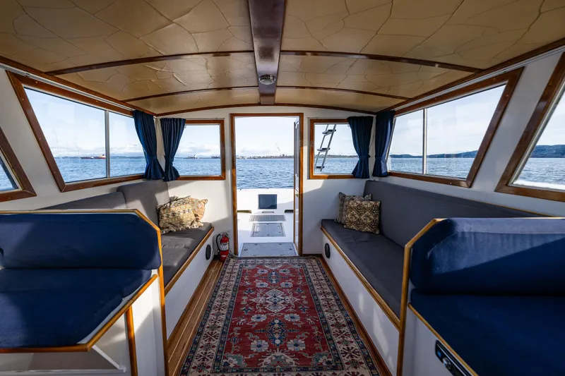 Slide: The Image of Interior of a 1999 Northern Bay 36 boat with cozy seating and scenic water views. - 15