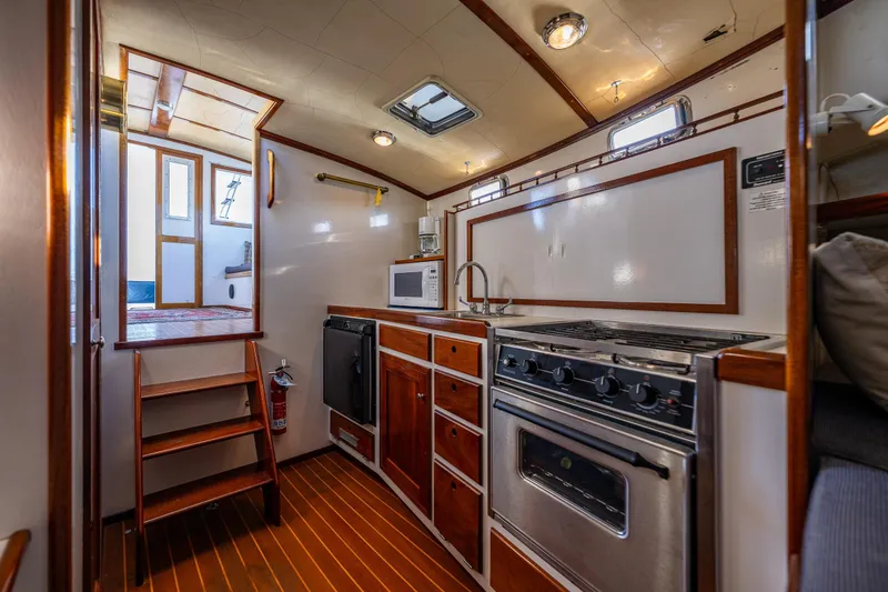 Slide: The Image of Cozy galley kitchen in 1999 Northern Bay 36 boat with wood accents and modern appliances. - 17