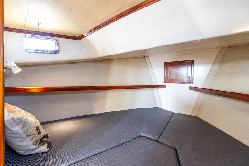 Slide: The Image of Cozy cabin interior of 1999 Northern Bay 36 boat with cushioned seating and wooden accents. - 19