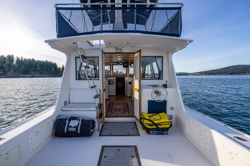 Slide: The Image of 1999 Northern Bay 36 boat interior with open cabin doors on calm water. - 7