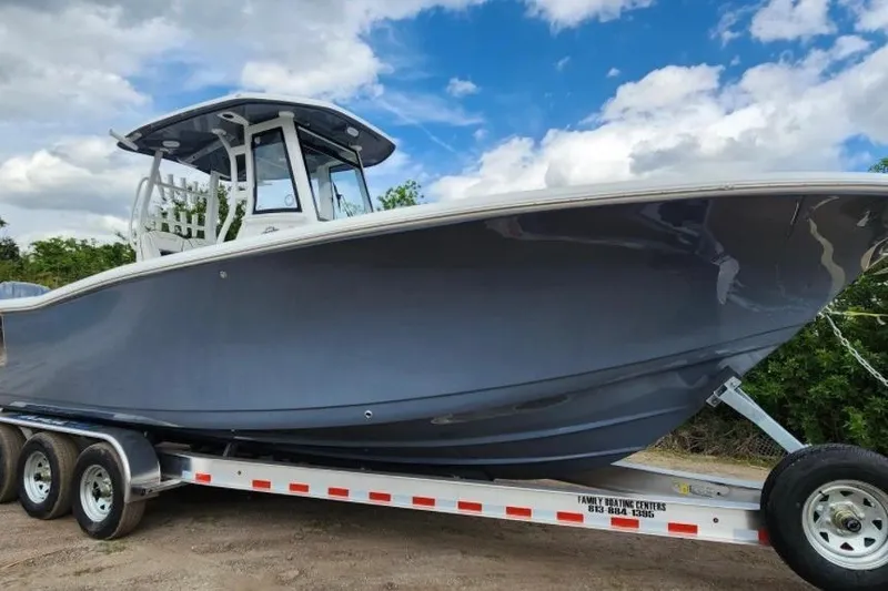 The Image of 2023 Tidewater 292 CC Adventure boat on trailer under blue sky. - 0