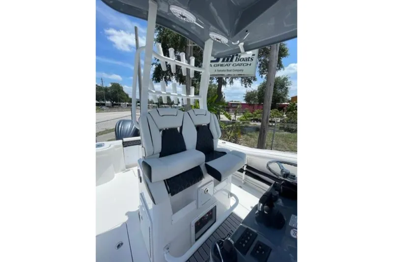 Slide: The Image of 2023 Tidewater 292 CC Adventure boat interior with dual seats and rod holders. - 10
