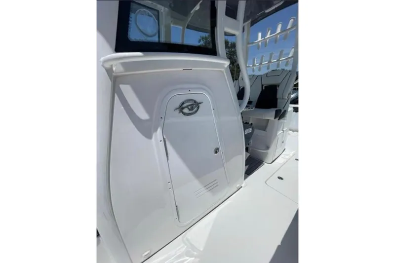 Slide: The Image of 2023 Tidewater 292 CC Adventure boat interior with seating and storage compartment. - 13