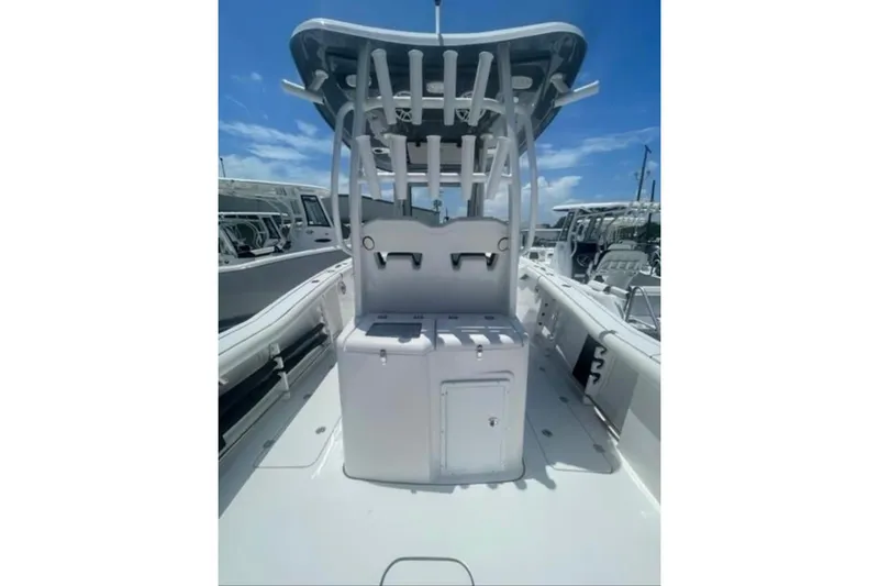Slide: The Image of 2023 Tidewater 292 CC Adventure boat interior with rod holders and storage compartments. - 16