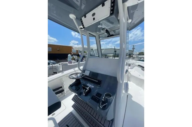 Slide: The Image of 2023 Tidewater 292 CC Adventure boat console with modern controls and steering wheel. - 18