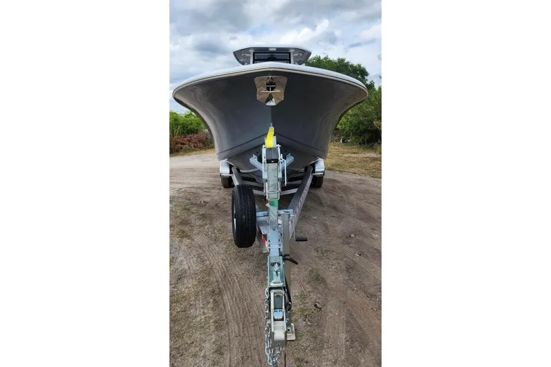 Slide: The Image of 2023 Tidewater 292 CC Adventure boat on trailer, front view, outdoors. - 4
