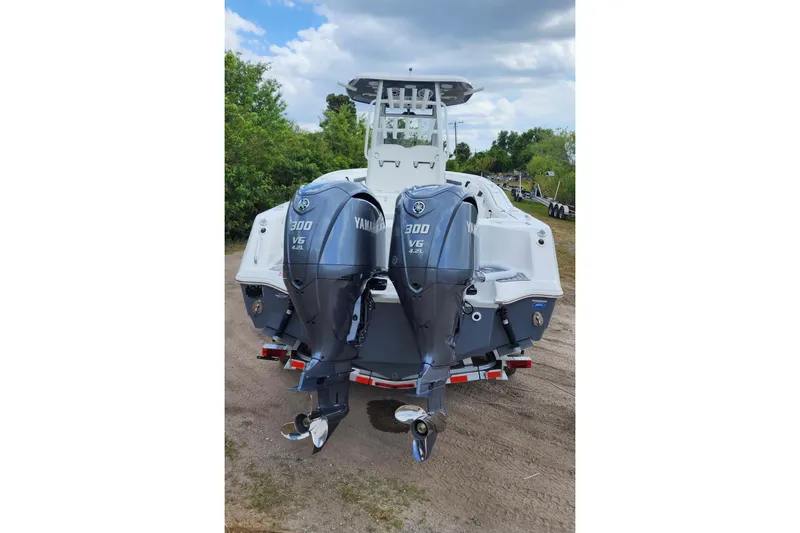Slide: The Image of 2023 Tidewater 292 CC Adventure boat with dual Yamaha V6 300 engines. - 5