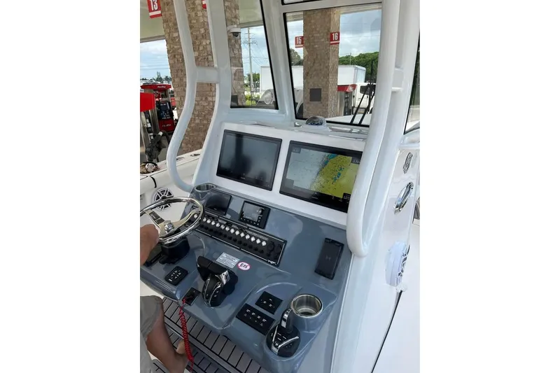 Slide: The Image of 2023 Tidewater 292 CC Adventure boat dashboard with navigation screens and controls. - 6
