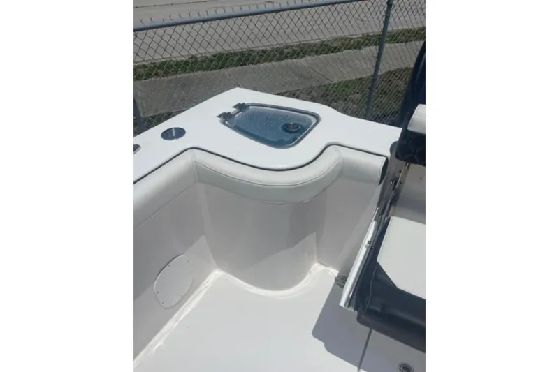 Slide: The Image of 2023 Tidewater 292 CC Adventure boat interior with seating and storage compartment. - 7