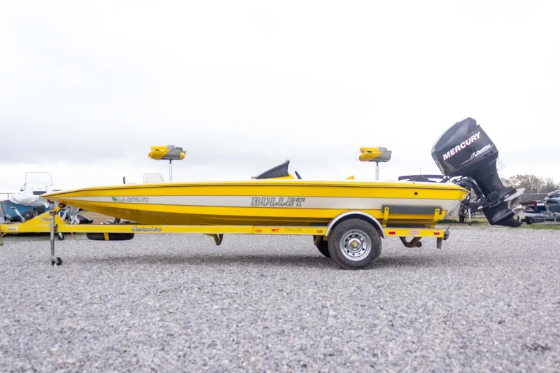 Slide: The Image of Yellow 2002 Bullet 20XDC boat with Mercury outboard motor on trailer. - 10