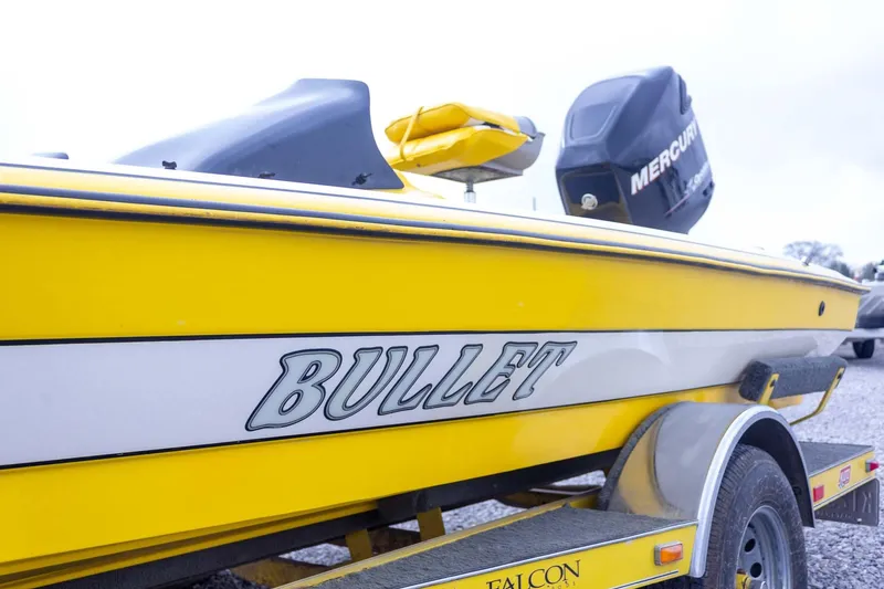 Slide: The Image of Yellow 2002 Bullet 20XDC boat with Mercury engine on trailer. - 11