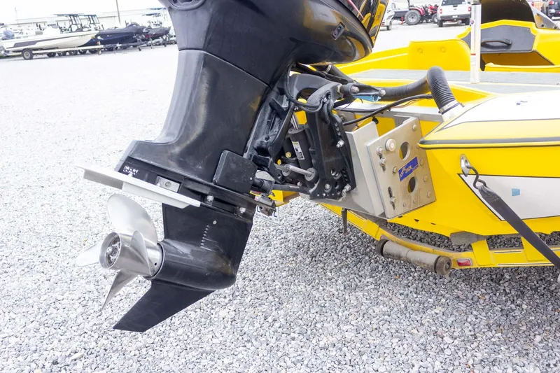 Slide: The Image of Yellow Bullet 20XDC boat from 2002 with an outboard motor and propeller. - 14
