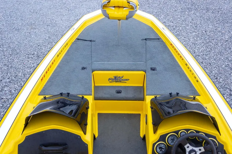 Slide: The Image of Yellow 2002 Bullet 20XDC boat interior with Mercury Racing branding and steering wheel. - 16