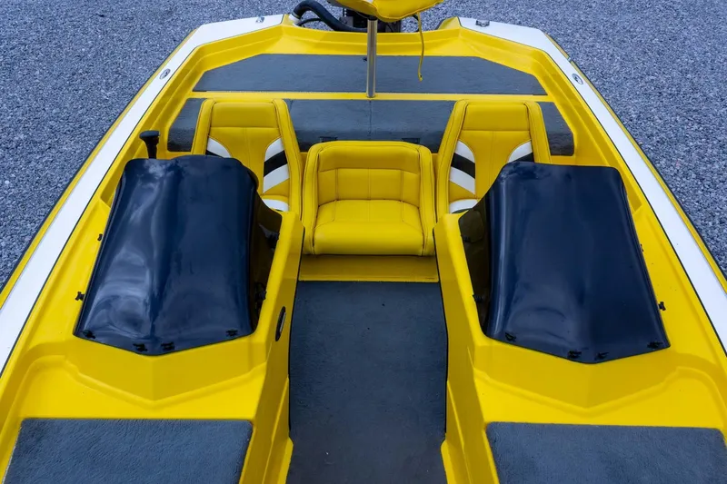 Slide: The Image of 2002 Bullet 20XDC boat interior with yellow and black seating, dual consoles. - 19