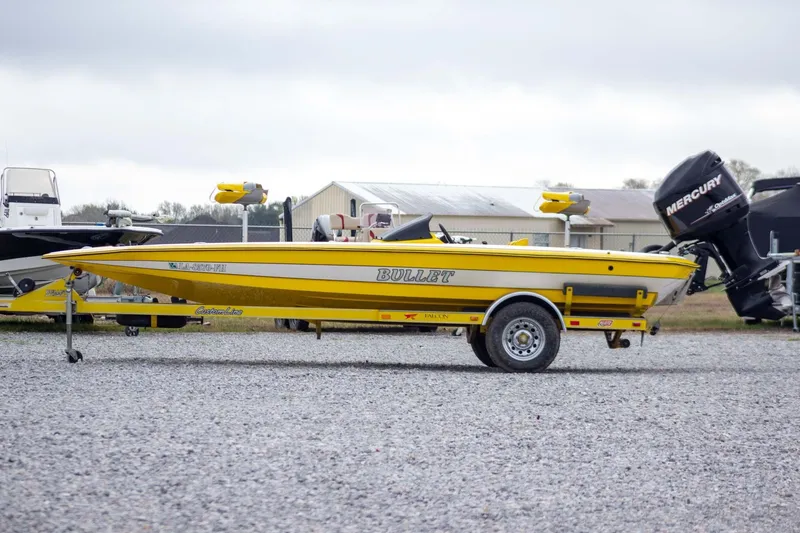 Slide: The Image of Yellow 2002 Bullet 20XDC boat on trailer with Mercury outboard motor. - 2