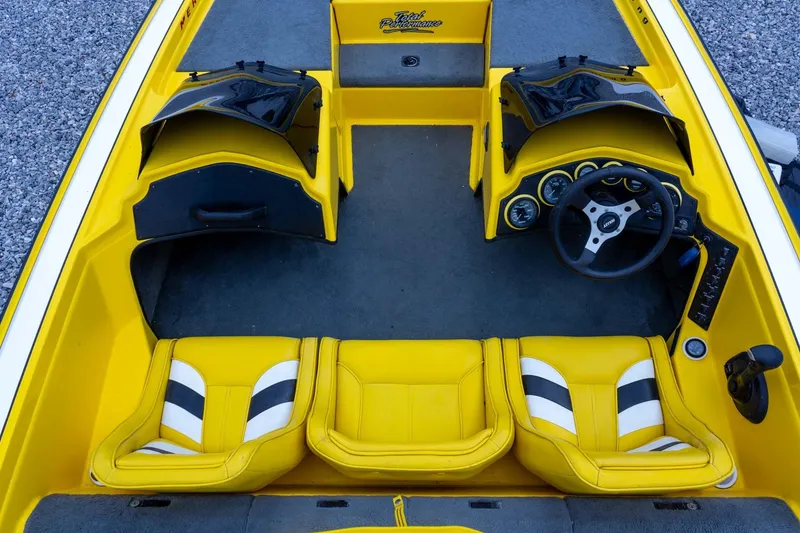Slide: The Image of Yellow 2002 Bullet 20XDC boat interior with dual seats and steering wheel. - 20