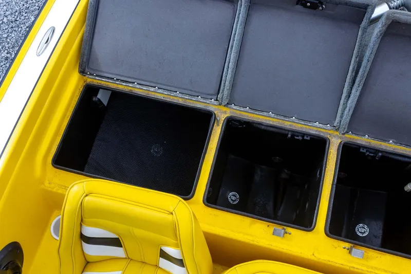 Slide: The Image of Yellow Bullet 20XDC boat interior with open storage compartments, 2002 model. - 28
