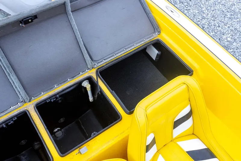 Slide: The Image of Yellow Bullet 20XDC boat interior with open storage compartments, 2002 model. - 29