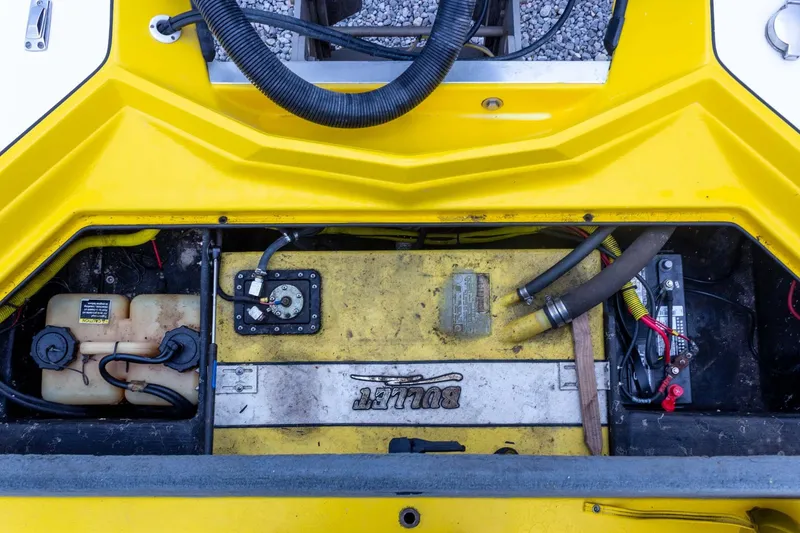 Slide: The Image of Engine compartment of a 2002 Bullet 20XDC boat, featuring yellow components and wiring. - 30