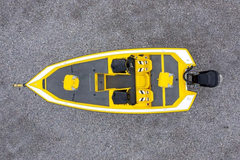 Slide: The Image of Overhead view of a 2002 Bullet 20XDC boat, yellow and gray design on gravel. - 31