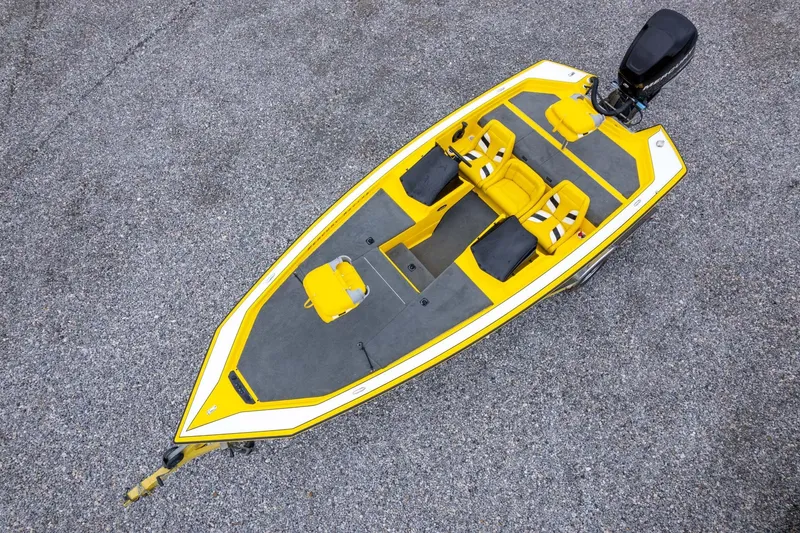 Slide: The Image of 2002 Bullet 20XDC boat, yellow and gray, aerial view on gravel surface. - 34