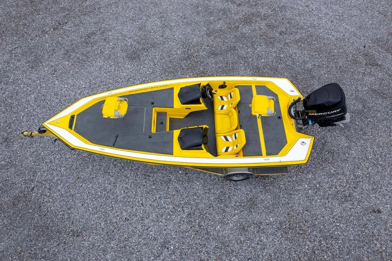 Slide: The Image of Yellow 2002 Bullet 20XDC boat with Mercury engine, viewed from above on gravel surface. - 35