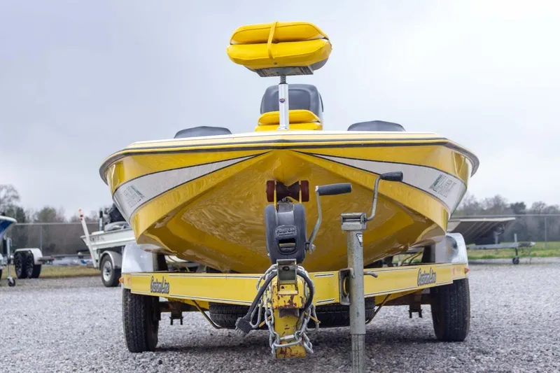 Slide: The Image of Yellow 2002 Bullet 20XDC boat on trailer, front view, parked on gravel. - 4