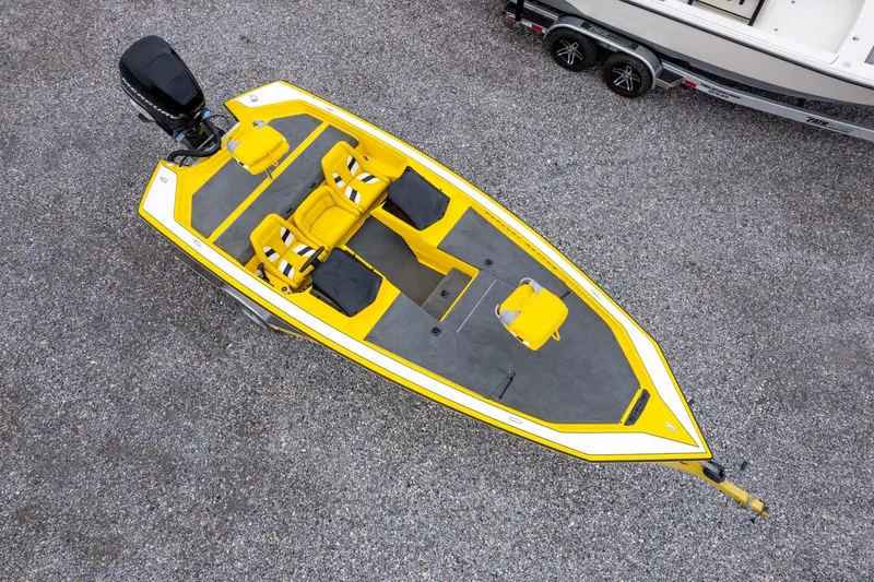 Slide: The Image of Yellow 2002 Bullet 20XDC boat with dual seats, viewed from above on gravel. - 40