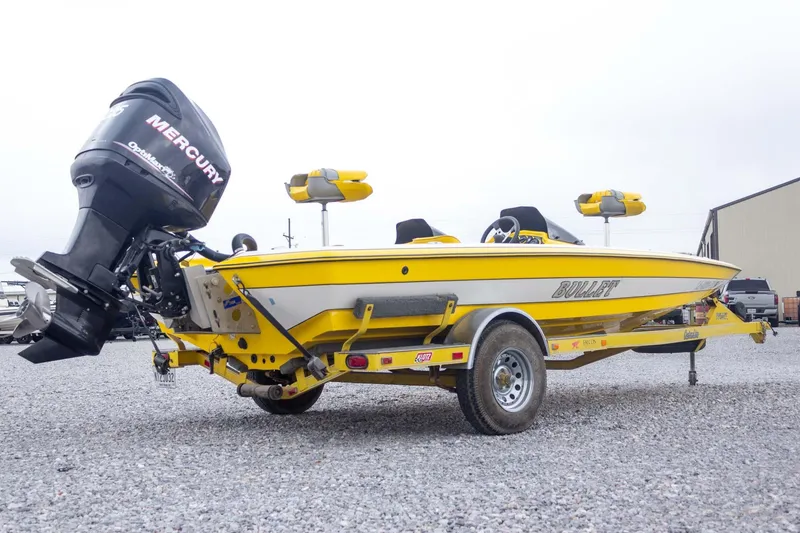 Slide: The Image of Yellow 2002 Bullet 20XDC boat with Mercury engine on a trailer. - 7