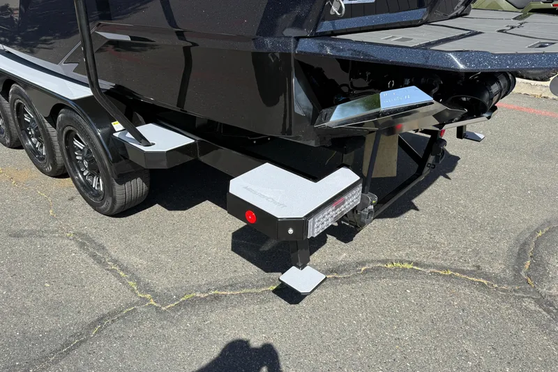 Slide: The Image of Rear view of a 2026 MasterCraft X24 boat trailer with triple axles. - 10