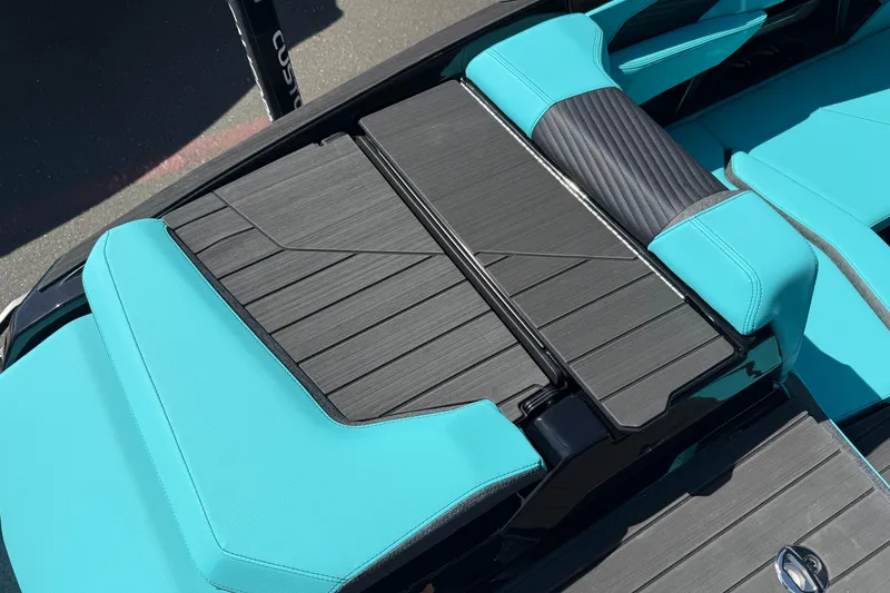 Slide: The Image of 2026 MasterCraft X24 boat interior with teal and black seating, showcasing modern design. - 21