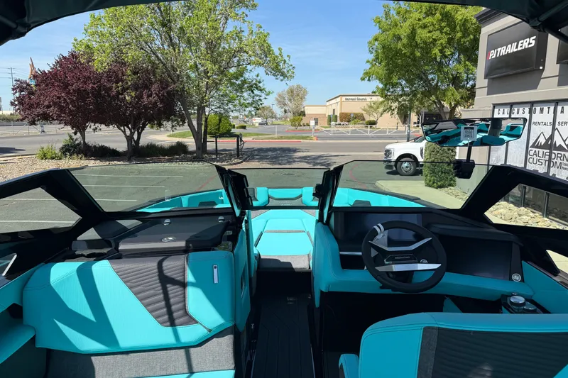 Slide: The Image of 2026 MasterCraft X24 boat interior with turquoise seating and modern dashboard. - 24